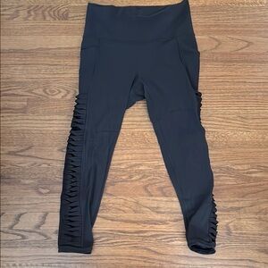 Athleta black Powervita 7/8 Leggings with Side Detailing, Size Medium